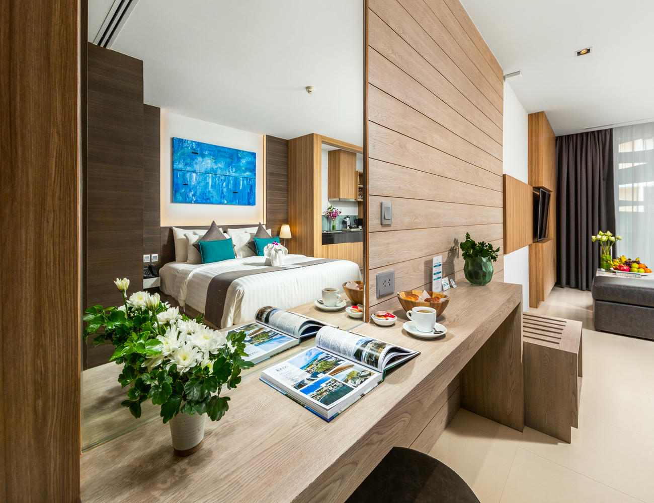 Deluxe Twin Room bedroom seen through mirror reflection, capturing a stylish and cozy interior