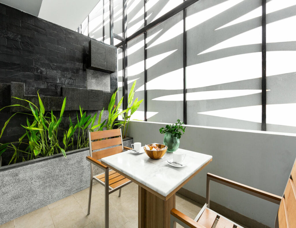 Relaxing corner in the Deluxe Twin Room with seating area for chatting or enjoying tea or coffee