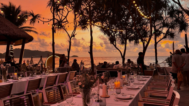 Wedding and group dining setup next to the beach at Kudo Hotel with elegant tables and ocean views
